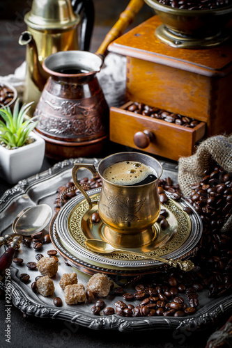 Black coffee in a cup on old background