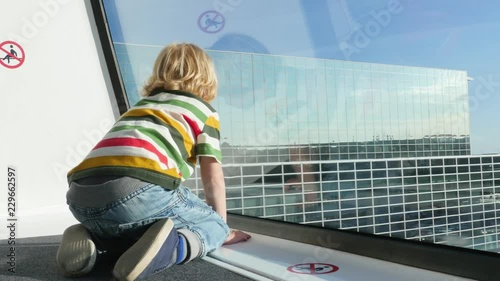 Boy is Sitting in the SkyLine and Looking Outside.