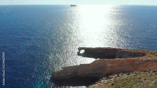 Drone shot over rocks in nature and towards a natural stone window on the Mediterranean sea of Malta 5 photo