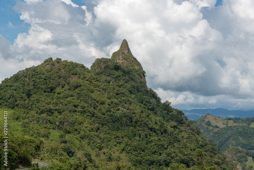 Peak of a mountain near dirt road in the foresta of the Colombian countryside on a sunny day. Colombia