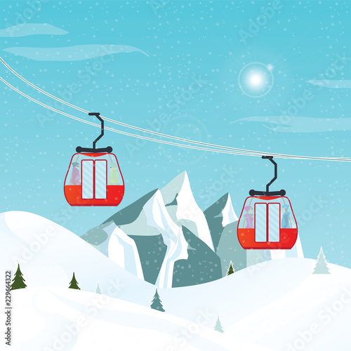 Cable cars or aerial lift moving above the ground against winter landscape.