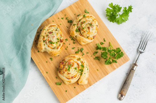 Sticky buns with feta, cream cheese, bacon and parsley on wooden board photo