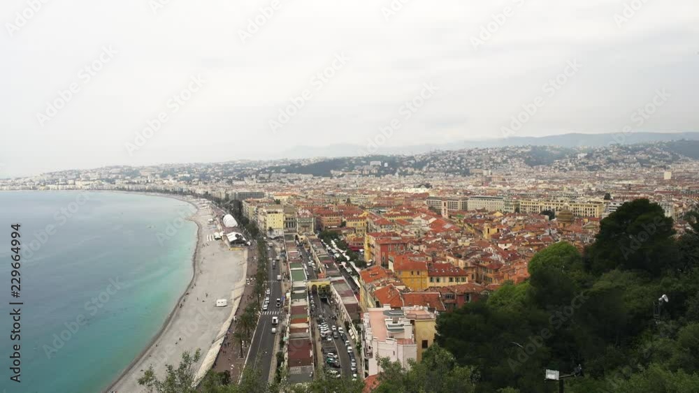 Panoramic shot of French city of Nice. Cars are driving. People swimming in sea. Luxury lifestyle concept. Right to left pan real time establishing shot Panoramic shot of French city of Nice. Cars are driving. People swimming in sea. Luxury lifestyle concept. Right to left pan real time establishing shot
