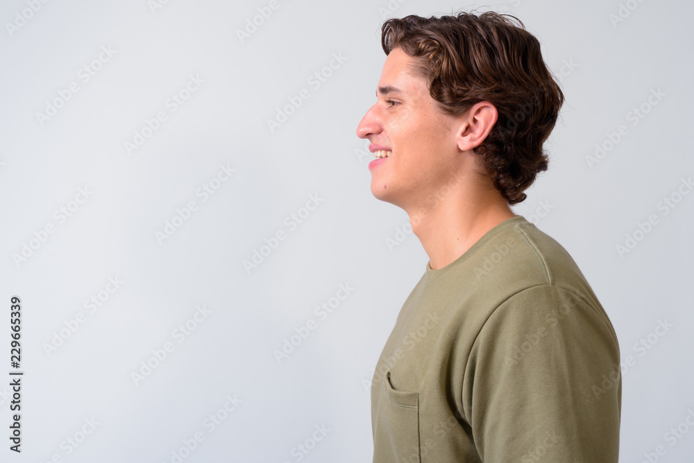 Young handsome man with wavy hair against white background Young handsome man with wavy hair against white background