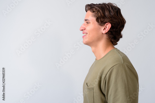 Young handsome man with wavy hair against white background