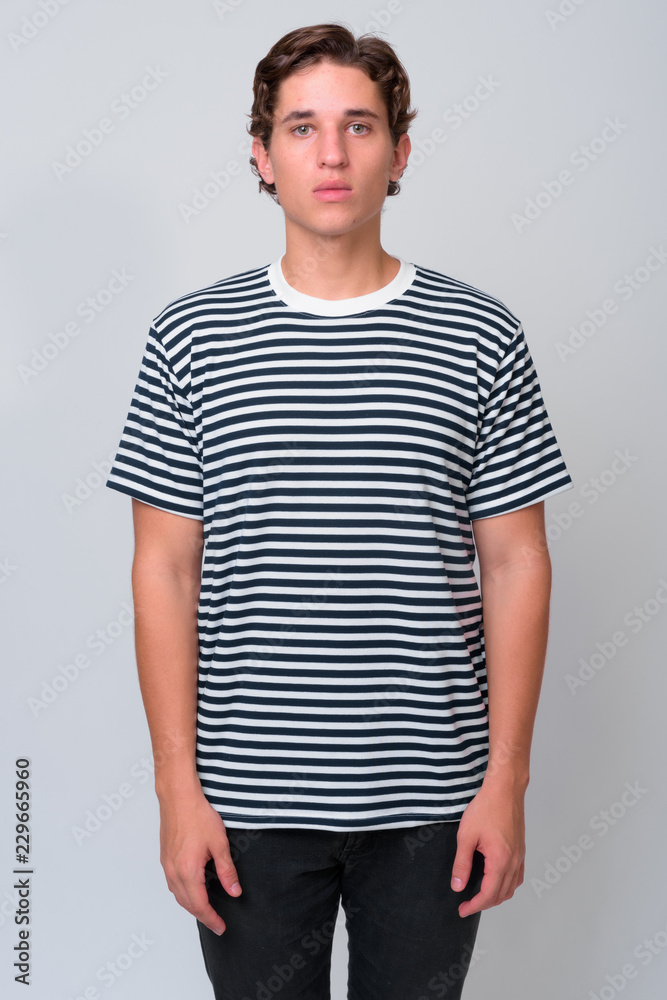 Young handsome man with wavy hair against white background Young handsome man with wavy hair against white background