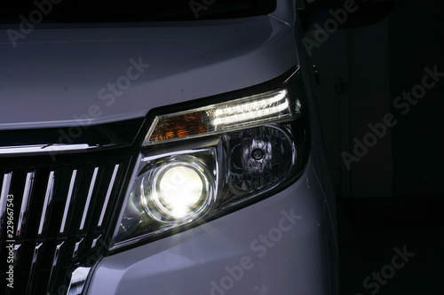 xenon headlight on a white car © Amnatdpp