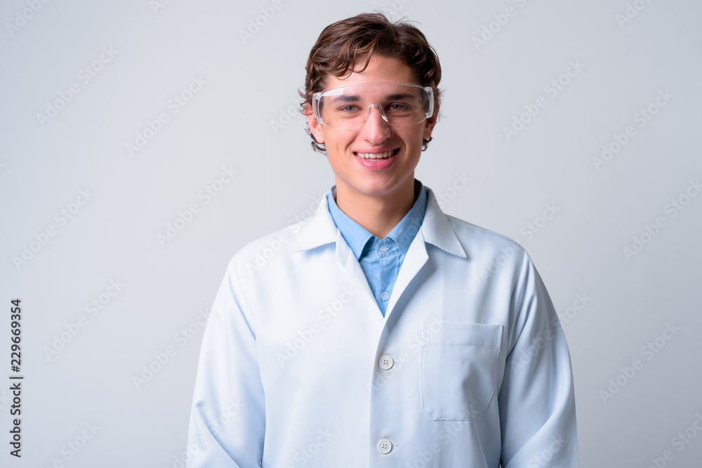Young handsome man doctor wearing protective glasses Young handsome man doctor wearing protective glasses