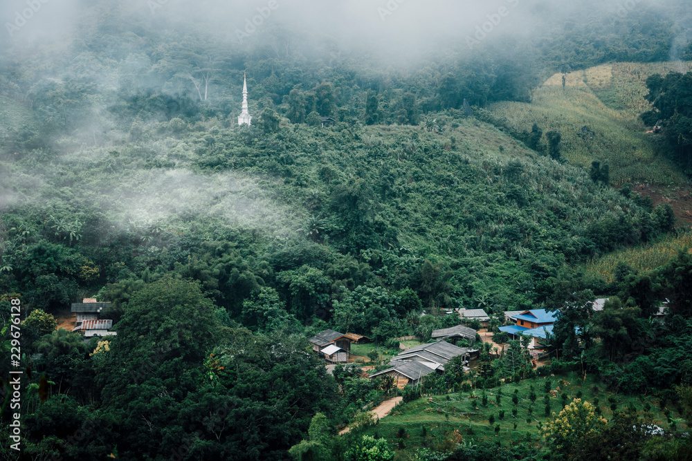 buildings in mountain village. Foggy day, Top view village landscape mist / Beautiful morning with fog over misty on village and mountain background on winter Mae Hong Son, Thailand