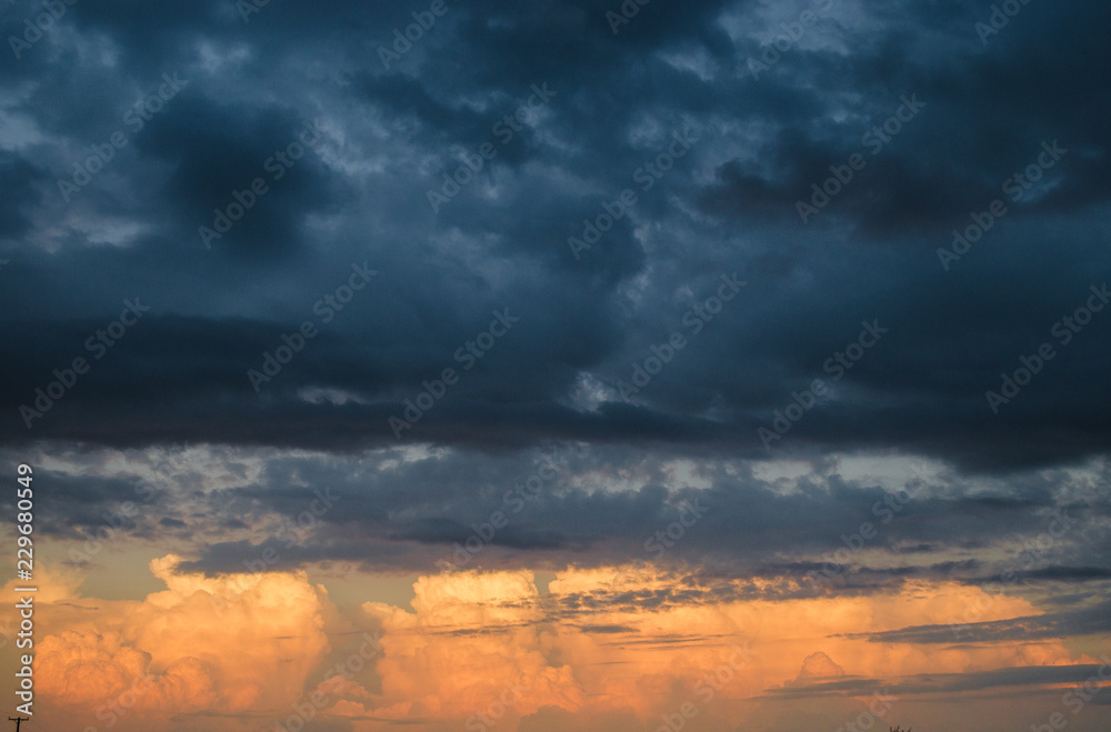 Beautiful sunset landscape with clouds painted with sunlight, sunset landscape, background with many clouds
