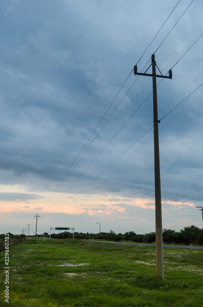 side road of a rural road, background of a cloudy landscape.