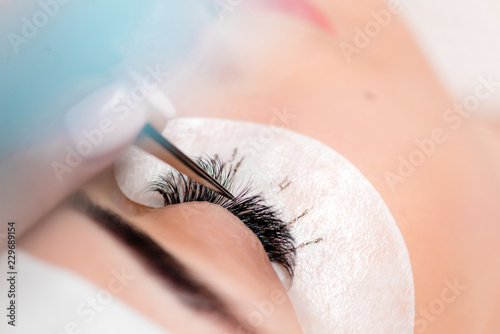 Eyelash Care Treatment Procedures: Staining; Curling; Laminating and Extension for Lashes. Beauty Model with Perfect Fresh Skin and Long Eyelashes. Skincare; Spa and Wellness. Close up.