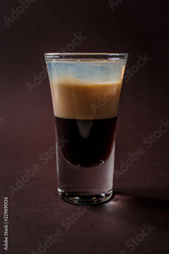 B-52 alcoholic shot glass on elegant dark brown background