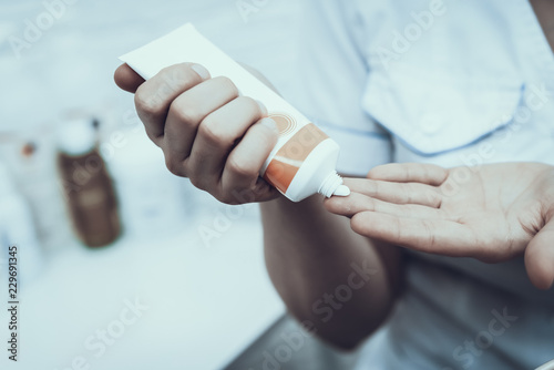 Close up. Doctor in White Coat with Cream on Hands