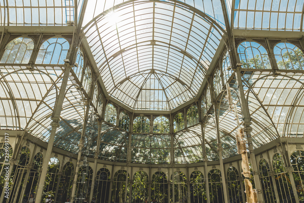 Palacio de Cristal del Retiro in Madrid, Spain. Inside property with view of the blue cel by behind glass