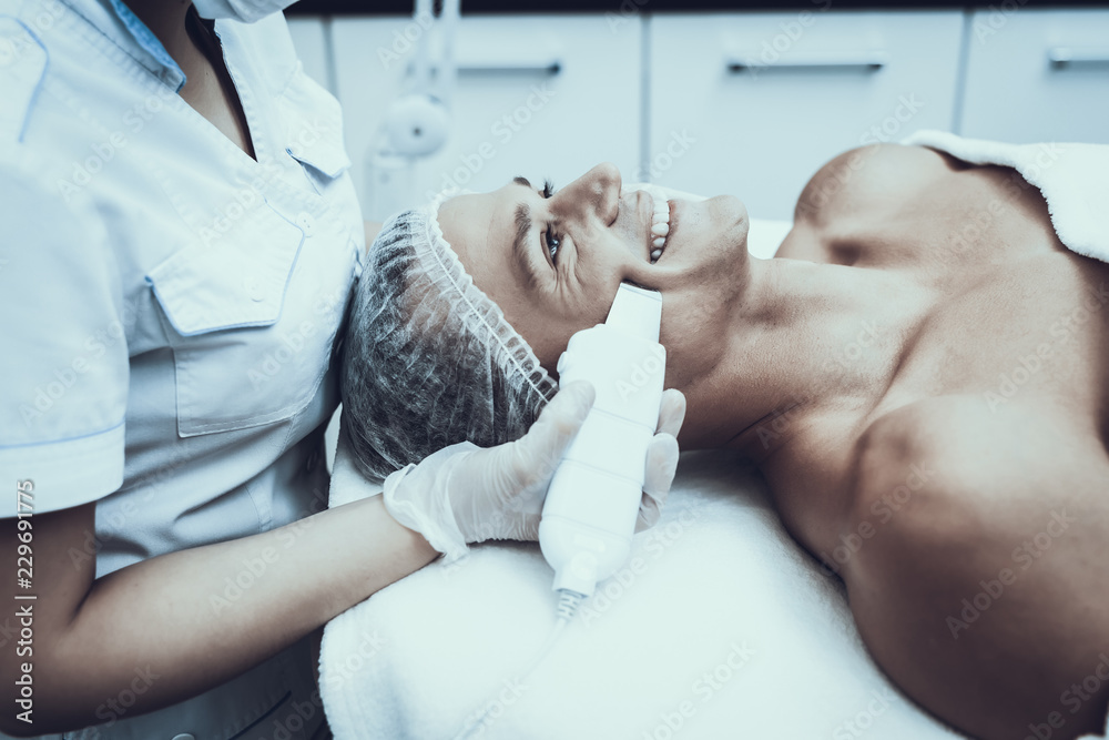 Young Man in Spa Salon for Laser Hair Removal.