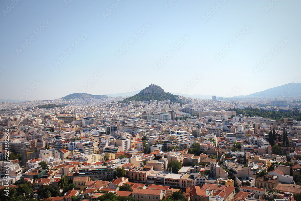 View over the city and the Lycabettus hill from Acropolis in Athens, Greece. Panorama of Athens . Beautiful cityscape with seashore