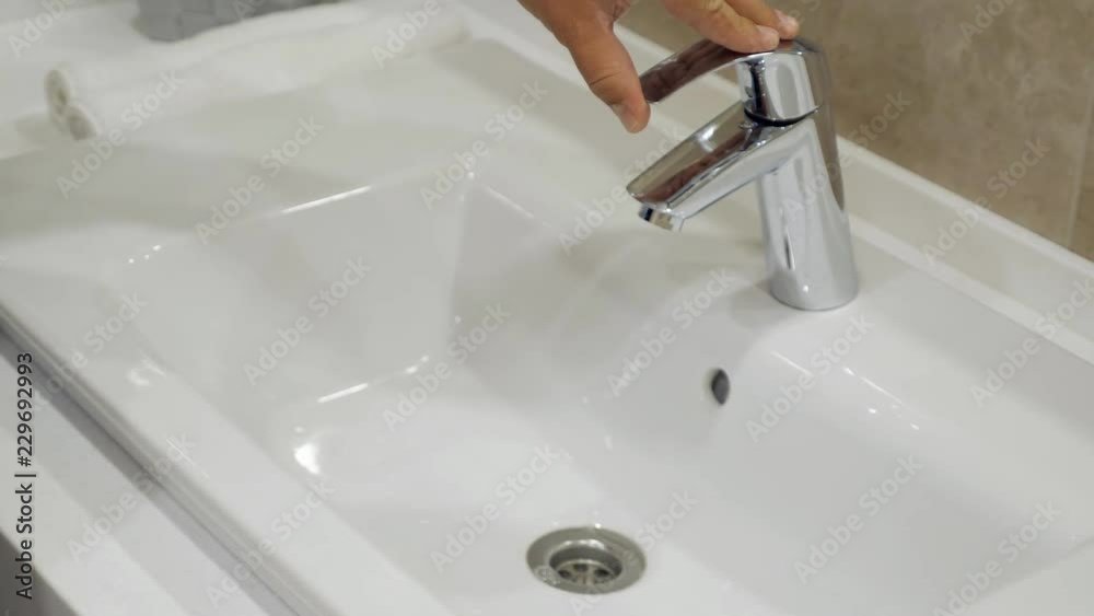 mens hand open the faucet in bathroom, slowmotion mens hand open the faucet in bathroom, slowmotion