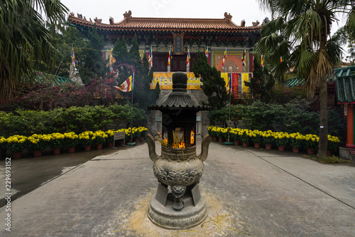 A decorated urn with burning incense sticks in the inner courtyard f Po Lin Monastery, Hong Kong, Ngong Ping, Lantau Island photo