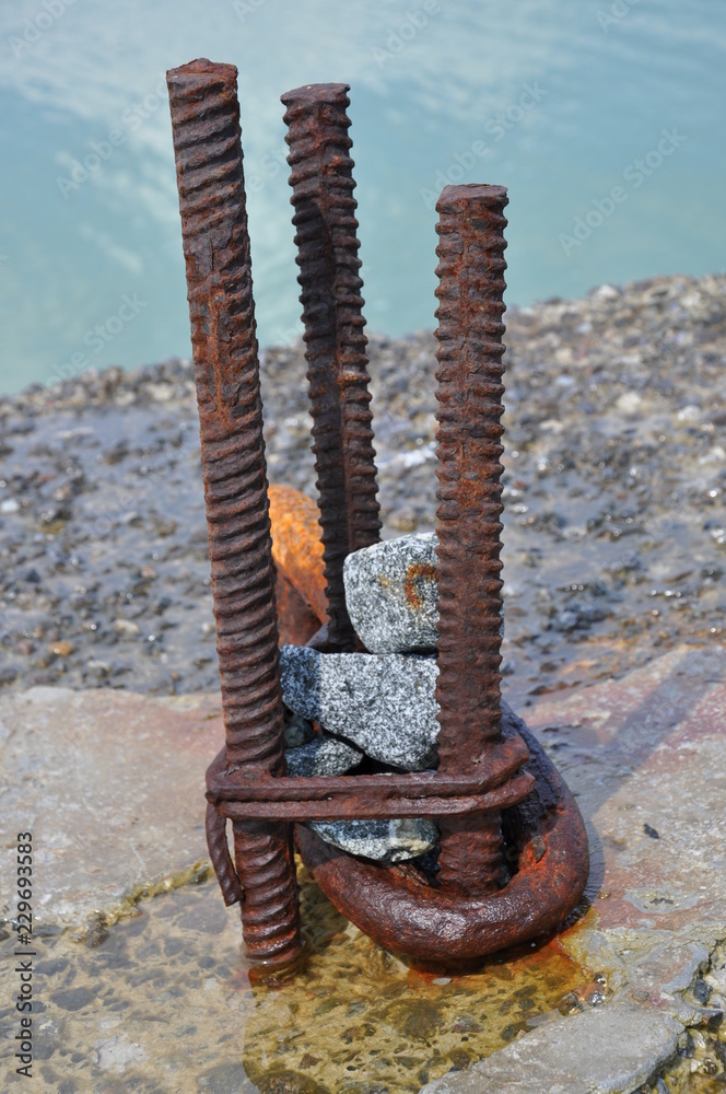 Anchorage bollard made from three old armature rods with granite stones ...