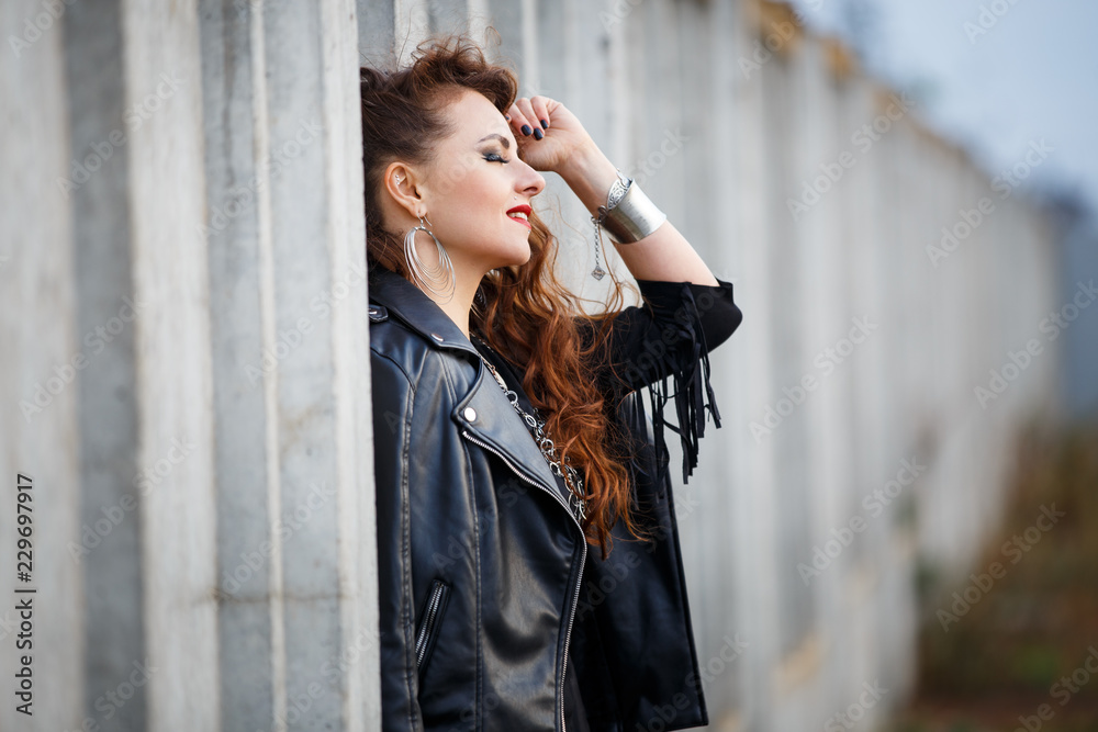 Obraz premium Rock style girl in leather jacket with long hair