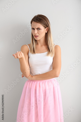 Indignant young woman on white background