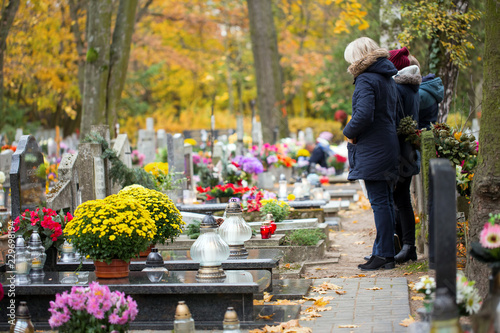 Family at the cemetery are praying at the grave photo