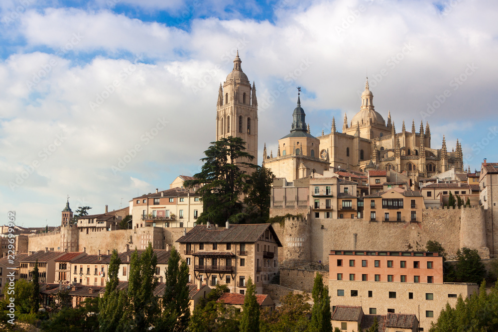 Mirador de Segovia with gothic cathedral, typical old houses, city wall. Trees, pinnacles and tower. Segovia, Spain