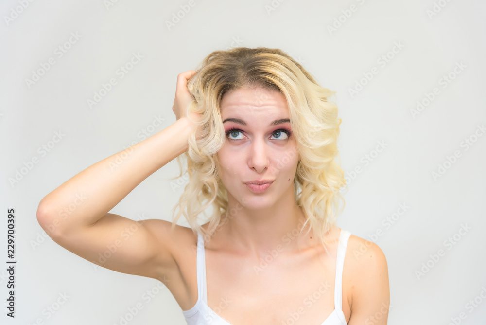 Beauty portrait of a beautiful blonde girl on a white background with perfect makeup.