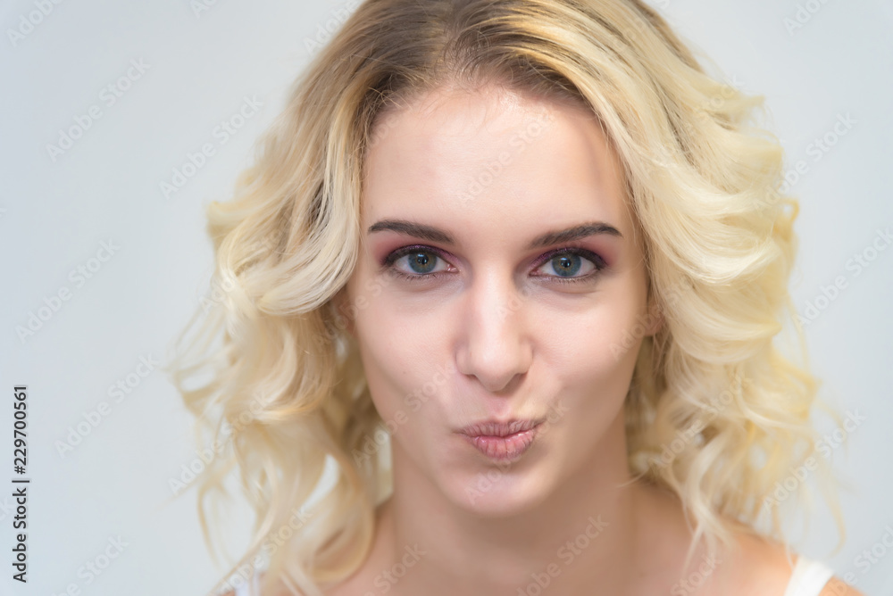 Beauty portrait of a beautiful blonde girl on a white background with perfect makeup. Beauty portrait of a beautiful blonde girl on a white background with perfect makeup.