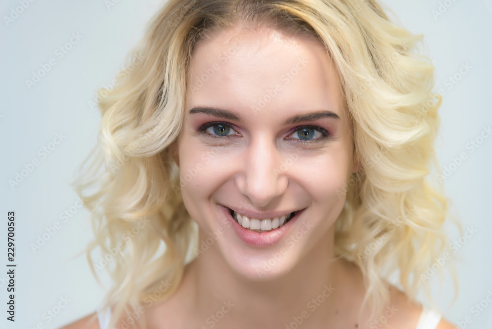 Beauty portrait of a beautiful blonde girl on a white background with perfect makeup. Beauty portrait of a beautiful blonde girl on a white background with perfect makeup.