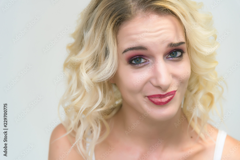 Beauty portrait of a beautiful blonde girl on a white background with perfect makeup. Beauty portrait of a beautiful blonde girl on a white background with perfect makeup.