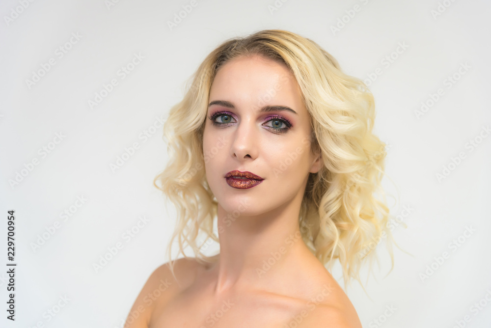 Beauty portrait of a beautiful blonde girl on a white background with perfect makeup. Beauty portrait of a beautiful blonde girl on a white background with perfect makeup.