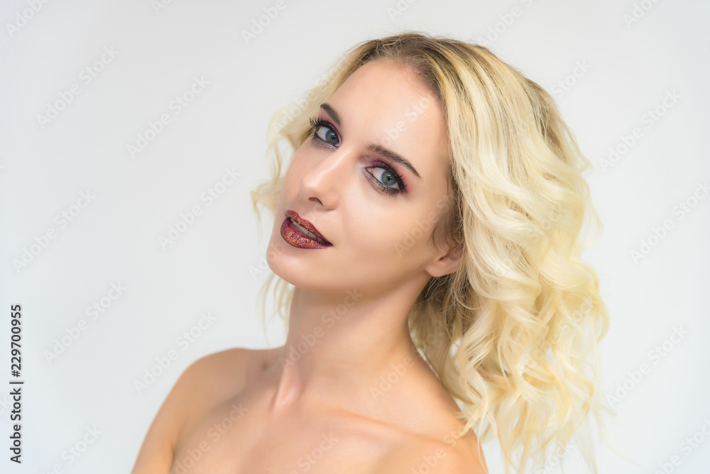 Beauty portrait of a beautiful blonde girl on a white background with perfect makeup. Beauty portrait of a beautiful blonde girl on a white background with perfect makeup.