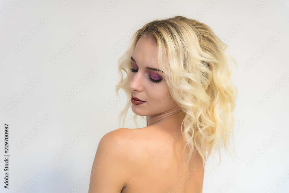 Beauty portrait of a beautiful blonde girl on a white background with perfect makeup. Beauty portrait of a beautiful blonde girl on a white background with perfect makeup.