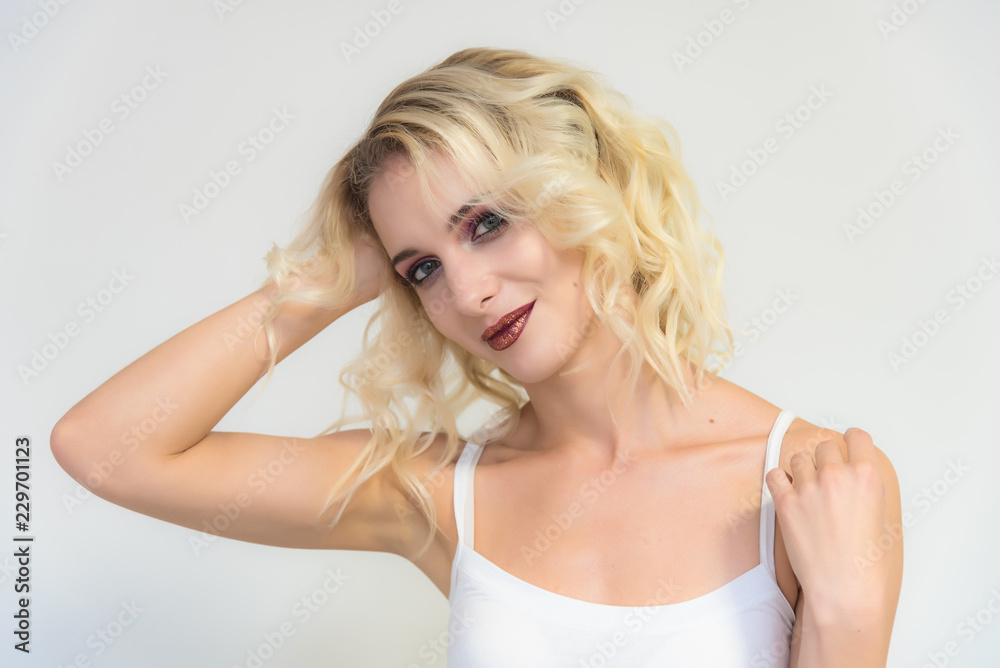 Beauty portrait of a beautiful blonde girl on a white background with perfect makeup. Beauty portrait of a beautiful blonde girl on a white background with perfect makeup.