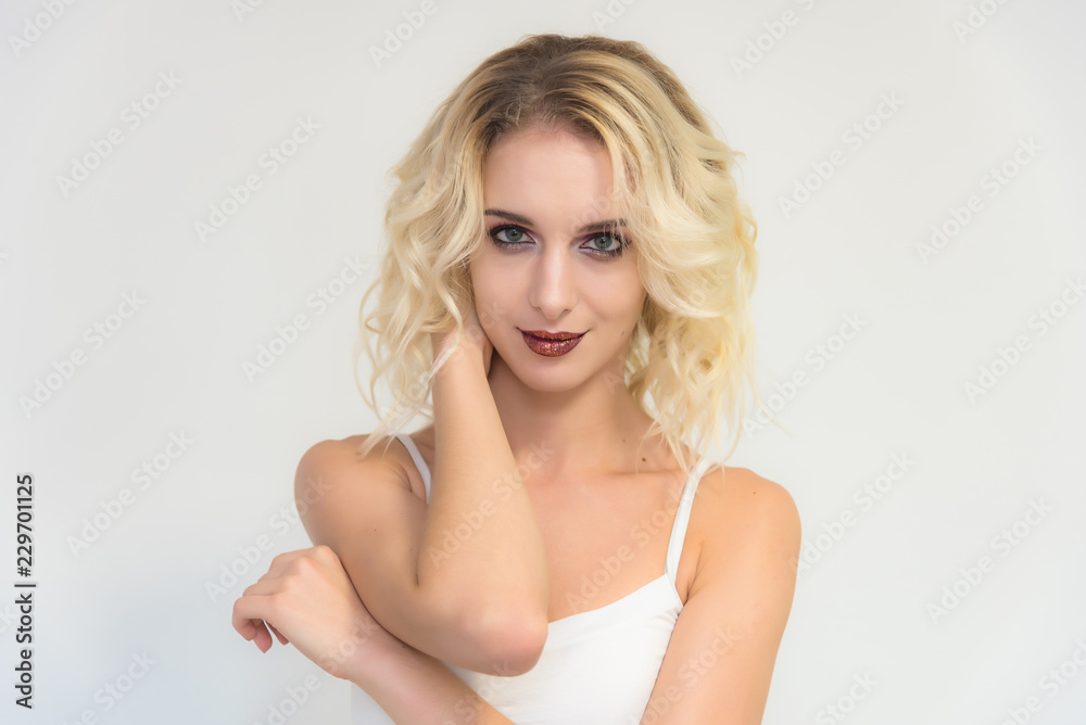 Beauty portrait of a beautiful blonde girl on a white background with perfect makeup. Beauty portrait of a beautiful blonde girl on a white background with perfect makeup.