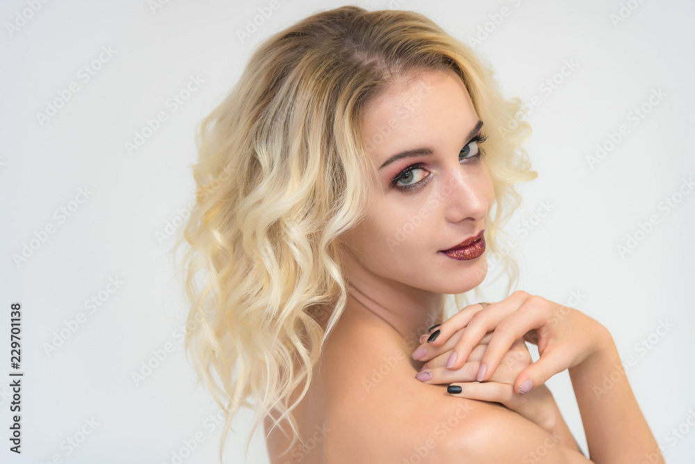 Beauty portrait of a beautiful blonde girl on a white background with perfect makeup. Beauty portrait of a beautiful blonde girl on a white background with perfect makeup.