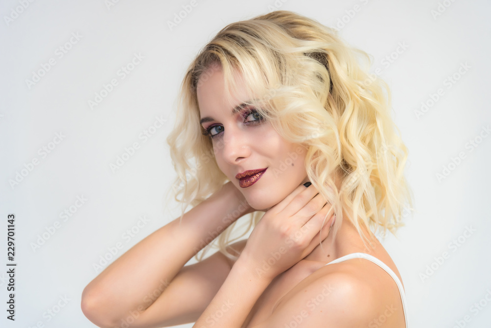Beauty portrait of a beautiful blonde girl on a white background with perfect makeup. Beauty portrait of a beautiful blonde girl on a white background with perfect makeup.
