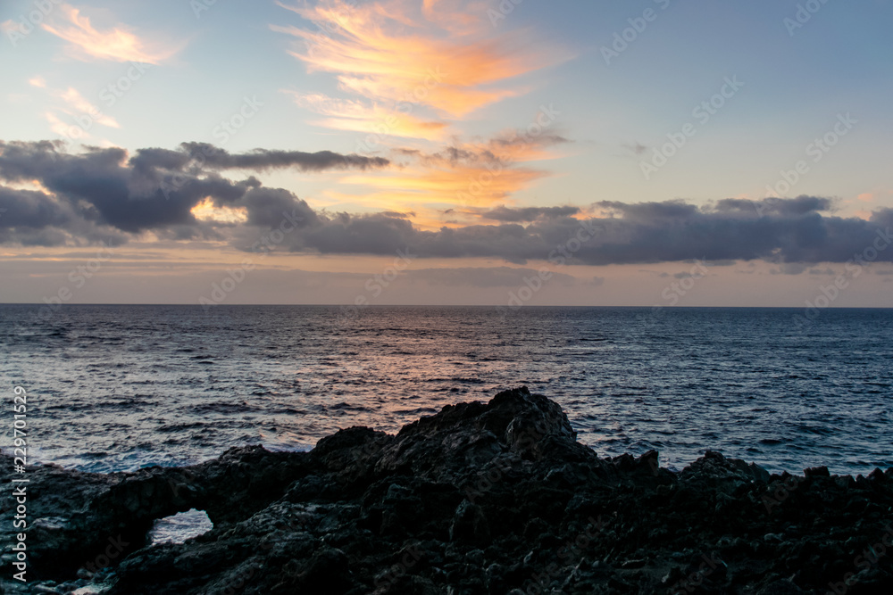 Sunrise over the Atlantic Ocean from Fuencaliente, La Palma with volcanic igneous rocks in the foreground