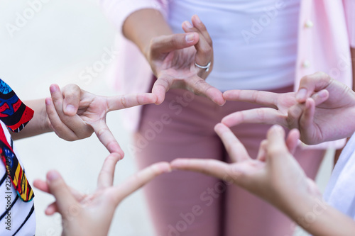 close up of hands children with teacher making gesture connecting to star shape together or Stars mark made by a finger. abstract ,symbol or Volunteer Teamwork ,Partnership and people concept