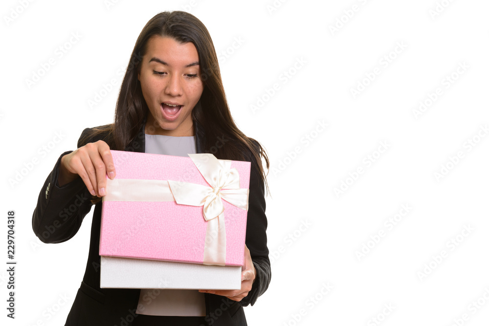 Young happy Caucasian businesswoman smiling and opening gift box Young happy Caucasian businesswoman smiling and opening gift box