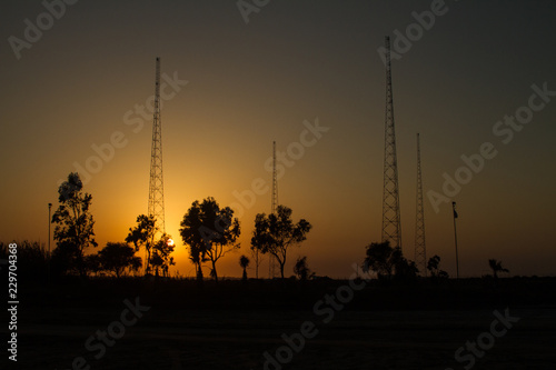 antennas in desert at sunset