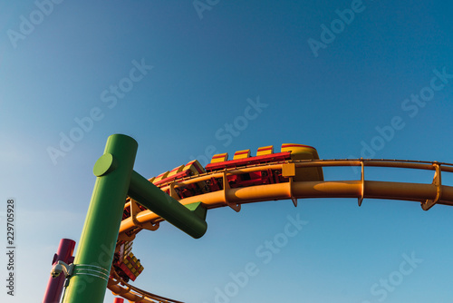 Roller coaster on blue sky background