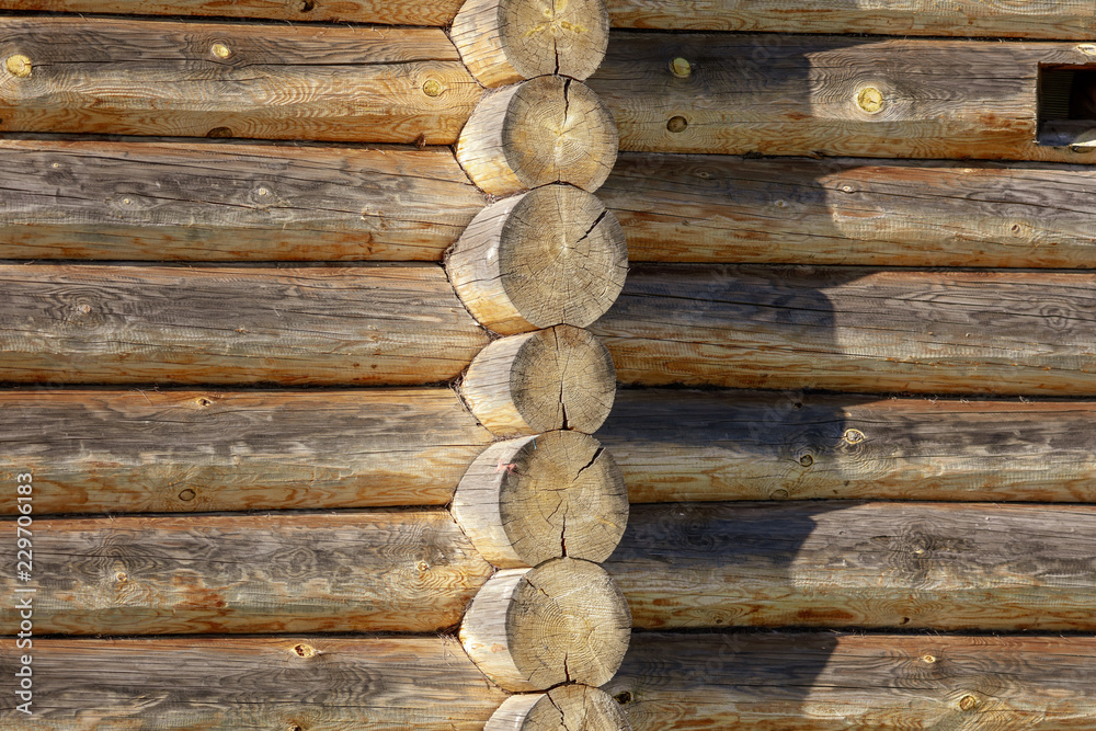 Wall with log house in the house as a background Wall with log house in the house as a background
