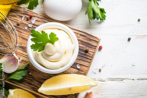 Obraz na plátně Mayonnaise sauce on white stone table.