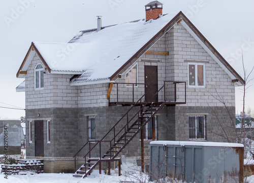 Country house cottage in the snow in winter