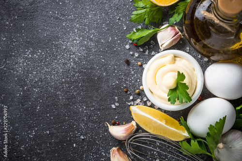 Mayonnaise sauce on black stone table.  photo