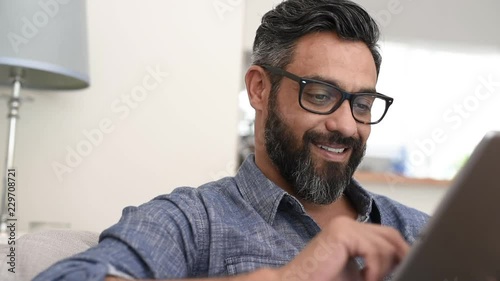 Mature man using digital tablet