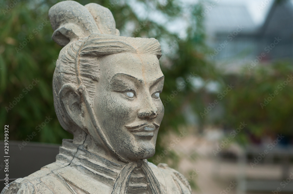 closeup of stoned statue in japanese garden closeup of stoned statue in japanese garden